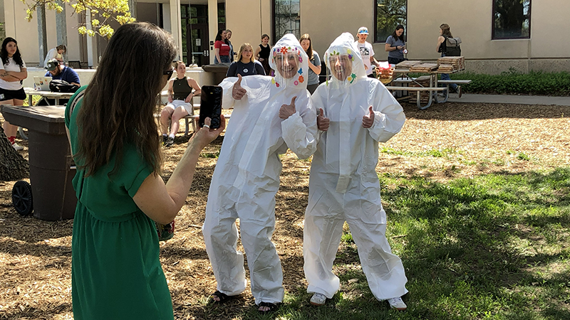 Lindsey Chizinski and Ann Powers in Hazmat suits.