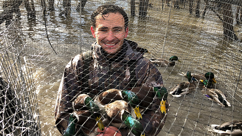 Ethan and ducks in a net