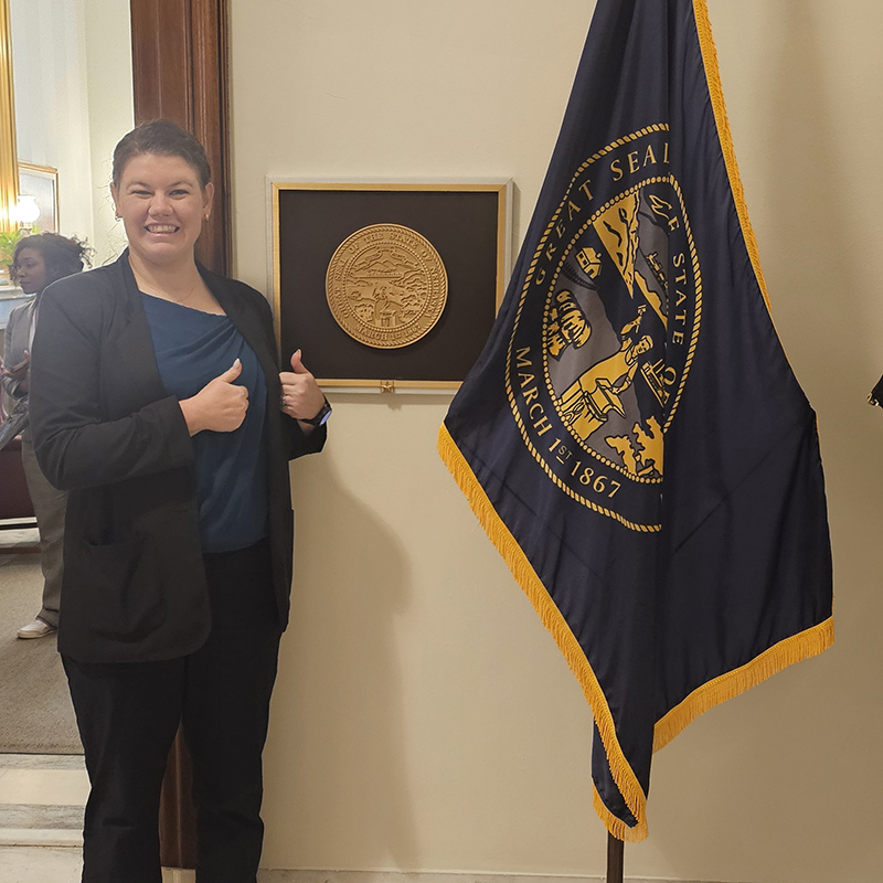 Sara Brock-Contreras and Nebraska flag