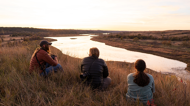 Three students by river