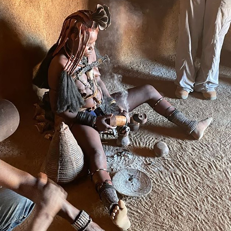 Ovahimba woman demonstrates a traditional smoke bath 