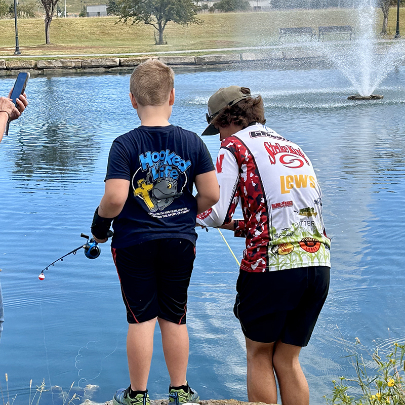 Logan Greeno with youth at church fishing event.