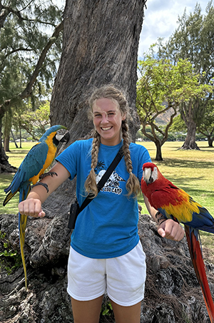 Emily with two macaws
